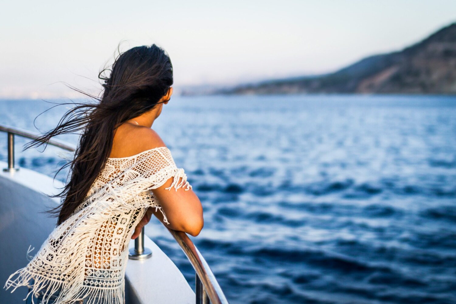 A guest at the rail looking out to sea on a day at sea A guest at the rail looking out to sea on a day at sea