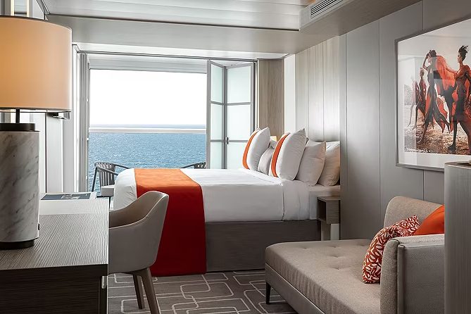 An Infinite Veranda stateroom with the glass doors folded open to the sea An Infinite Veranda stateroom with the glass doors folded open to the sea