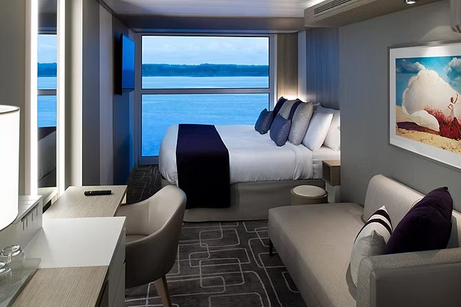 An Ocean View stateroom with a floor-to-ceiling window onto the sea An Ocean View stateroom with a floor-to-ceiling window onto the sea